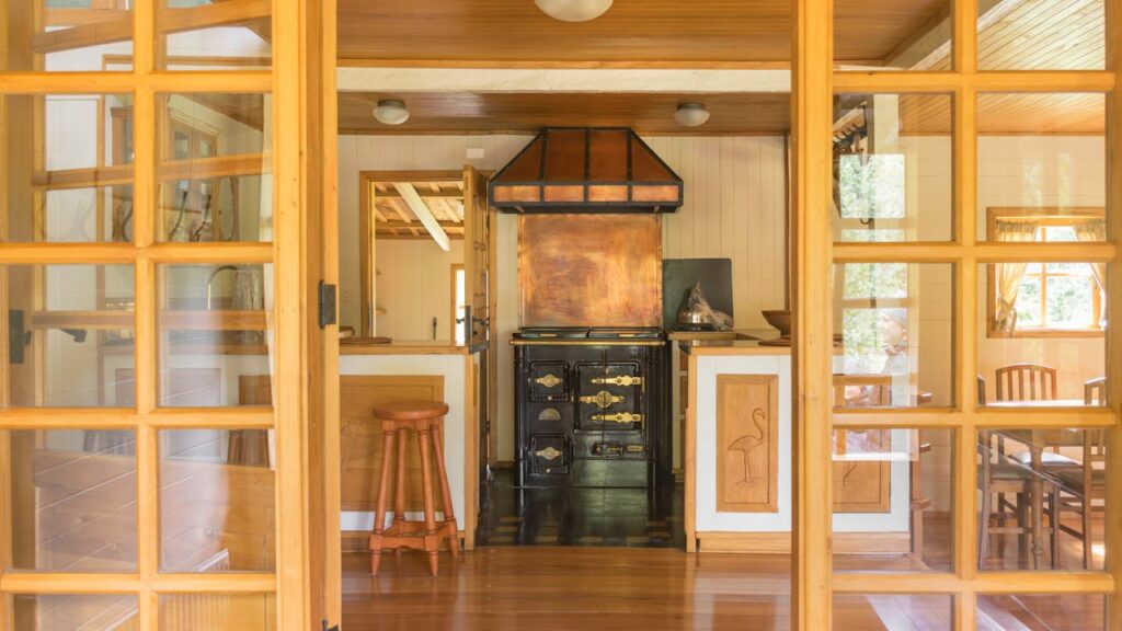 pexels photo 14596477 Warm rustic kitchen interior featuring a vintage stove and wooden furniture, offering a glimpse of nostalgic charm.