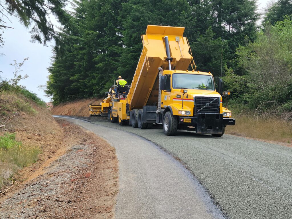 pexels photo 17605956 17605956 A yellow dump truck paving a forest road in Langlois, Oregon, USA.